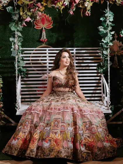 The full view of Nisha's unique printed lehenga. The makeup was kept glamorous yet balanced to let the outfit shine.
