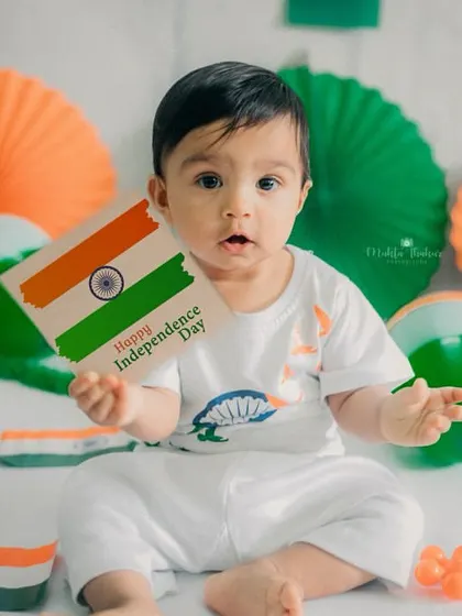 Holding up an Independence Day card for the camera. This posed shot is a perfect way to commemorate the special occasion.