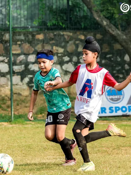 A young player from Ardee School challenges for the ball, showing great spirit.
