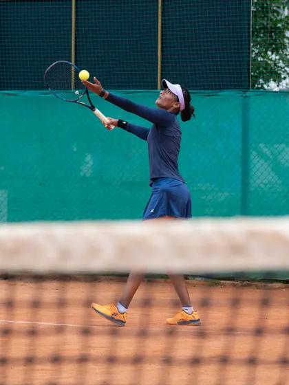 A close-up of a player's service toss and preparation. Consistency in the small details leads to consistency in the game.