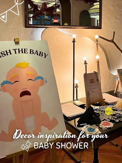 "Hush the Baby" is a fun take on the classic "pin the tail on the donkey" game. Guests are blindfolded and have to try and place the pacifier on the crying baby.