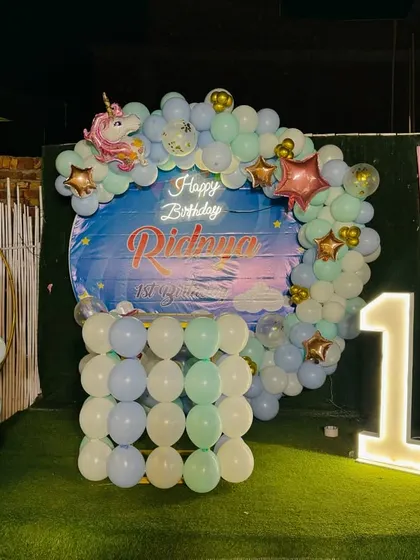 The magical unicorn birthday decoration set up at night, with the lights creating a beautiful effect.