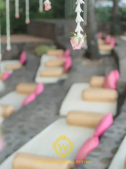 A mix of traditional floor seating and elegant Tiffany chairs for a wedding ceremony. This arrangement respects the venue's unique amphitheater layout while ensuring guest comfort.