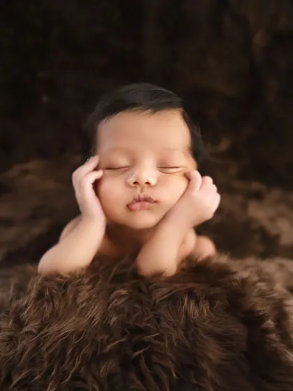 The classic 'froggy' pose, always done safely with composite images. This pose is perfect for showing off a newborn's sweet, squishy cheeks and tiny features.