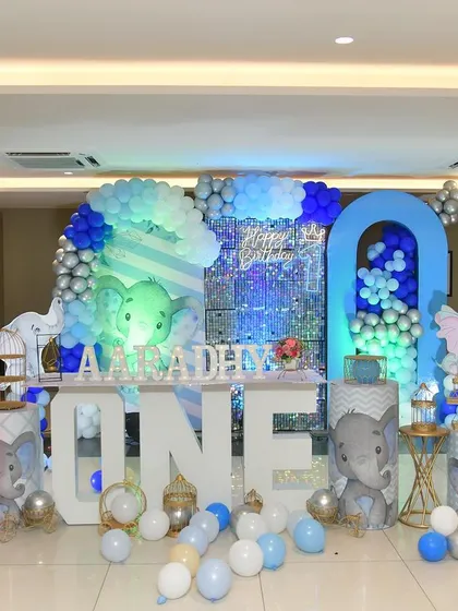 The full view of the baby elephant stage, featuring a large 'ONE' sign and themed pedestals.