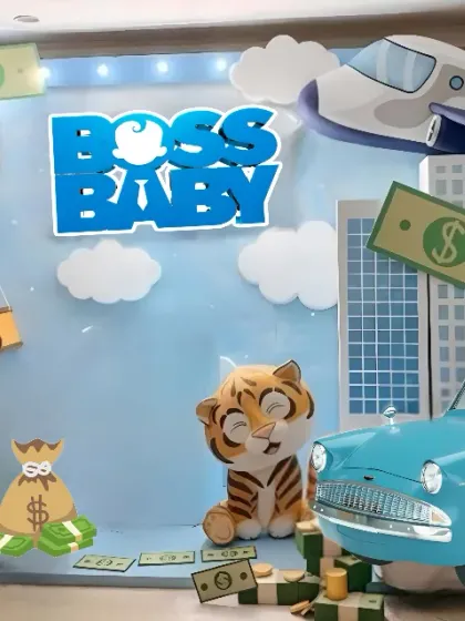 The complete setup for a fun Boss Baby party. The backdrop includes a city skyline, an airplane, and a vintage car, with plenty of fun props for photos.