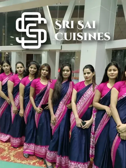 We can deploy large, coordinated teams for grand-scale events. This image shows a large contingent of our service staff from Mumbai, all in matching navy and pink sarees, ready to manage guest services for a big fat Indian wedding or a large corporate gala.