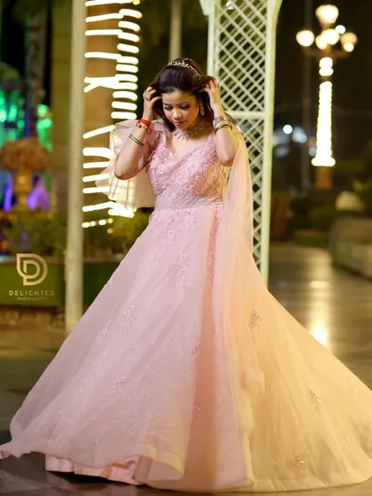 A candid portrait of the bride-to-be adjusting her tiara, capturing a natural and elegant moment before the main celebration.