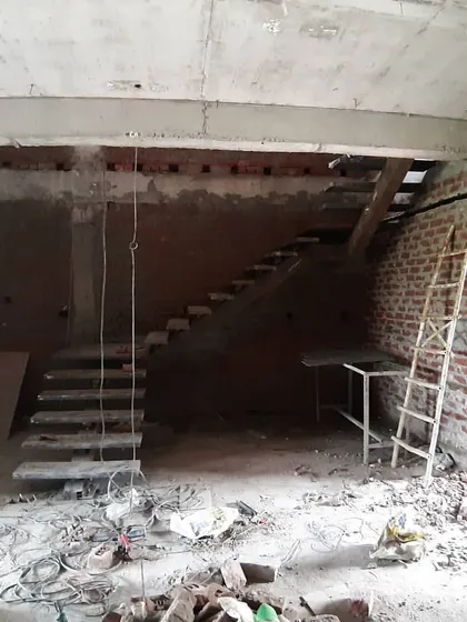 The raw form of a duplex staircase. This structure, made of concrete and steel, will later be finished with wood and glass to become a central feature of the home.