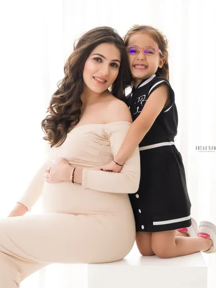 A sweet hug from behind, showing the close bond between a mother and her daughter during this special time of waiting.