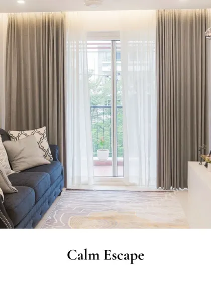 This calm escape captures the essence of relaxation with its muted tones and natural textures, featuring an inviting dark sofa, flowing curtains, and understated decor.