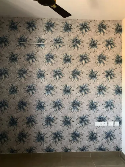 A repeating pattern of a spiky blue flower, adding a unique and modern floral touch to this room.