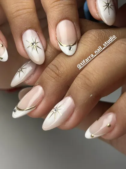 Another view of the elegant celestial nails, showing how different art on each hand can create a cohesive yet unique look. We teach you how to design creative and balanced sets.