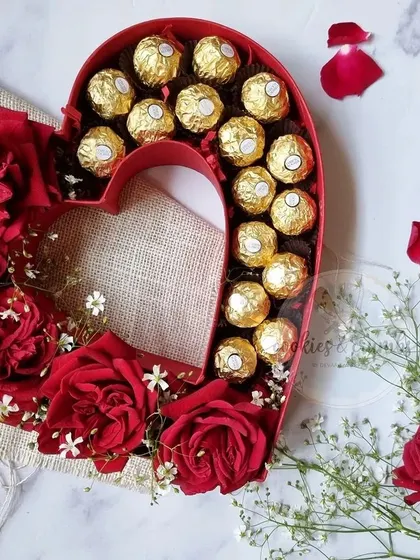 A classic gesture of love. This heart-shaped box combines lush red roses with decadent Ferrero Rocher chocolates, making it a perfect gift for Valentine's Day or anniversaries.