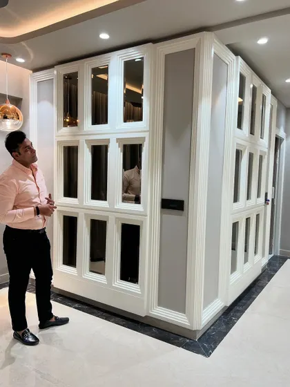 Inspecting the details of the mirrored wall feature. The beveled edges and clean paneling are crucial for achieving this high-end look.