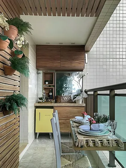 This balcony has been converted into a mini dining and bar area. We built a custom wooden cabinet unit with a countertop and space for a mini-fridge.