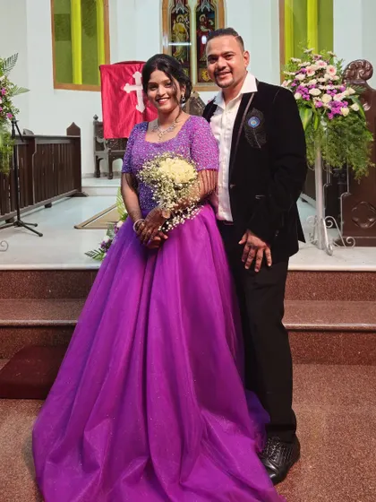 A beautiful couple ready for their ceremony. The bride's choice of a vibrant purple ball gown is a stunning and unique look for a modern wedding.