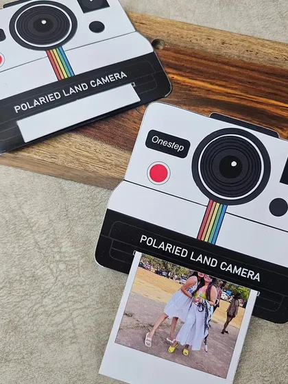 This Insta Cam Pull-Up Card is a creative way to present a photo. The card is shaped like a vintage polaroid camera, and the picture slides out from the bottom.