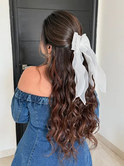 Another angle of this perfect bow-pinned hairstyle. The extensions ensure the hair looks thick and healthy, providing a beautiful base for the accessory.