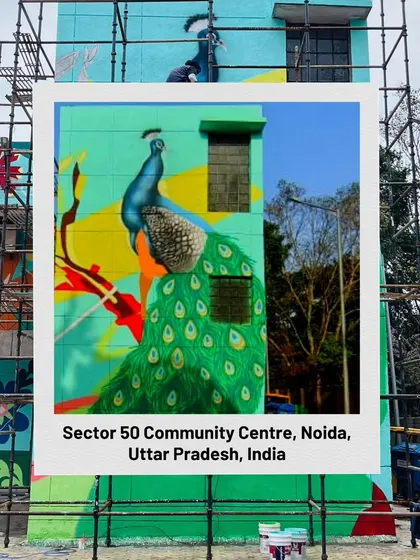 A progress shot of the peacock mural being painted. This image was used to showcase the neighborhood transformation initiative supported by the HCL Foundation.
