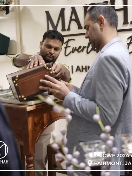 A client examining the craftsmanship of one of my leather-finished boxes at ICWF 2024. It's these hands-on interactions that allow the quality of my work to truly shine.
