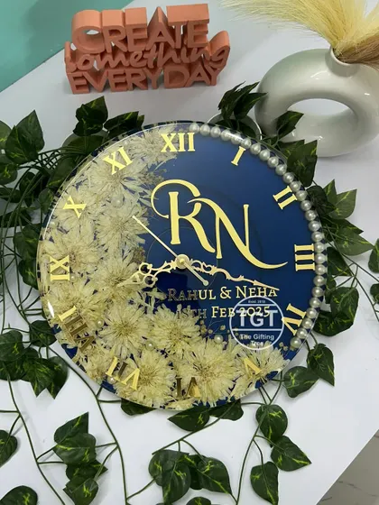This top-down angle highlights the layout of the 12-inch clock, from the custom monogram to the placement of the preserved varmala flowers and pearl accents.