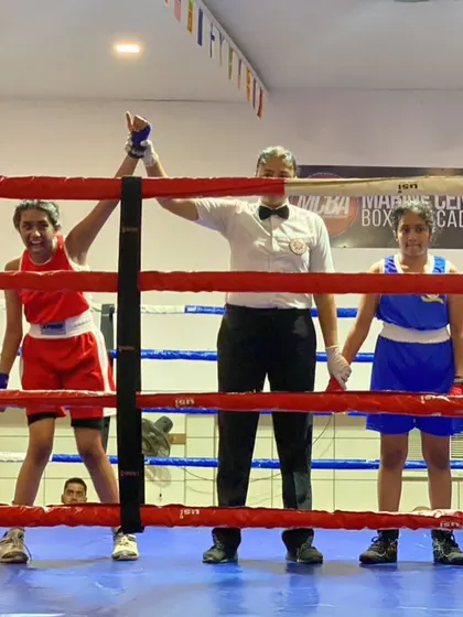 The moment of victory. One of our young boxers has her arm raised by the referee after a hard-fought win. We prepare our fighters for competitive bouts at district, state, and national levels.