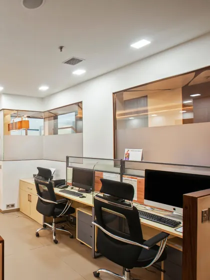 A thoughtfully designed office space nestled within a larger residence, offering both privacy and natural light. The neutral wooden tones are accented with a beautiful pop of orange for warmth.