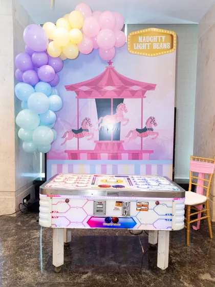 A 'Naughty Light Beans' reaction game table, where players have to quickly press the buttons that light up.