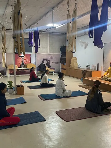 A full view of a meditation workshop in progress, with students from all walks of life coming together to find stillness.