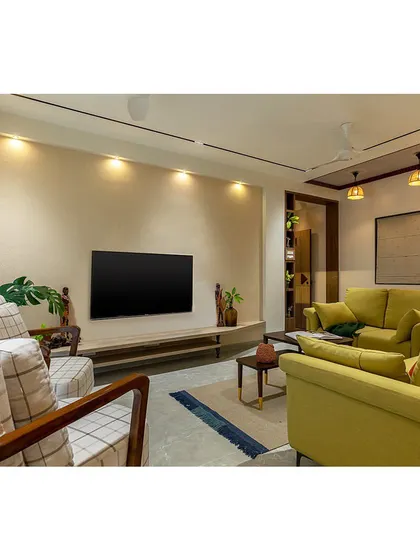 This shot showcases the entire living room layout, designed for an elderly couple and their family. The space is warm, welcoming, and rooted in comfort, with easy-to-navigate pathways.