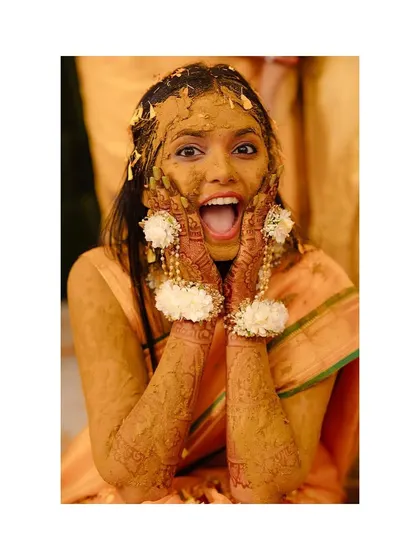 The aftermath of a fun Haldi! The bride's shocked and delighted expression is absolutely priceless.