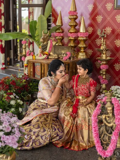 A mother's gentle kiss on her daughter's hand, a small but powerful gesture of love captured during the festivities.