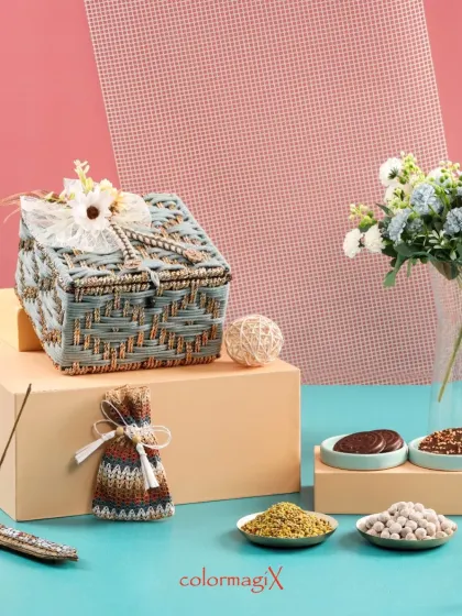 A closed view of our grey jute hamper, highlighting the intricate weaving and delicate floral embellishment on top.