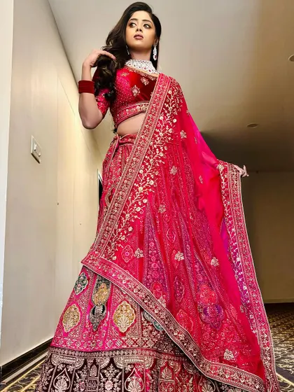 This image shows the intricate embroidery of the lehenga and how the modern CZ jewellery enhances the overall bridal reception look.