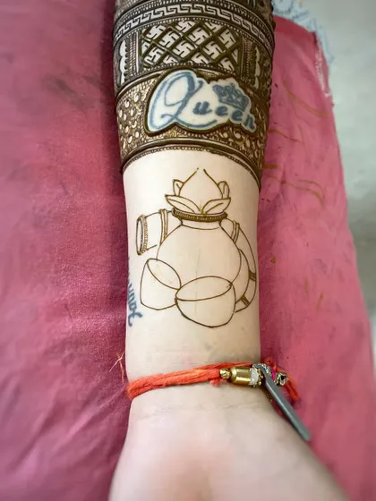 The outline for a Karva Chauth themed design, showing the kalash (pot) before the intricate details are added.