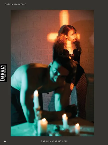 A tense, cinematic moment from the Darkly Magazine shoot, using shadows and colored light.