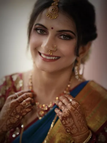 A beautiful, happy portrait. The makeup is clean and bright, with a focus on enhancing her natural features and beautiful smile.