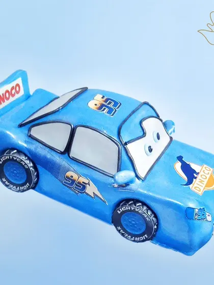 A blue Lightning McQueen cake, ready to race. This cool design is a fun twist on the classic red car, perfect for a "Cars" movie fan.