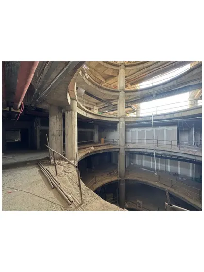 The multi-level atrium under construction at Sant Nirankari Hospital. These open corridors surrounding the central void foster a sense of connection and visibility, reinforcing the hospital's commitment to patient-centric care.
