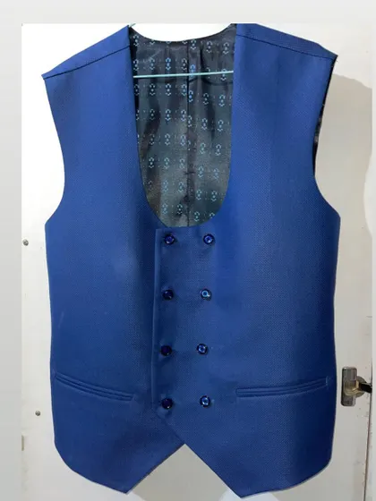 The details make the difference. This is a double breasted waistcoat I stitched, featuring a unique U-neck design and a beautiful patterned inner lining. I can create waistcoats as part of a three piece suit or as a separate piece to elevate your formal look.