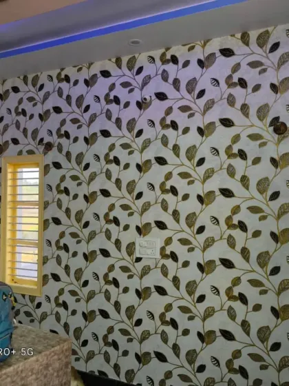 A climbing vine wallpaper in neutral tones, installed in a room with multiple windows.