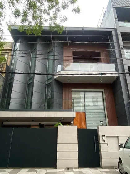 The real-life photograph of the completed project. This comparison highlights our ability to execute complex architectural details, like the angled windows, with precision.