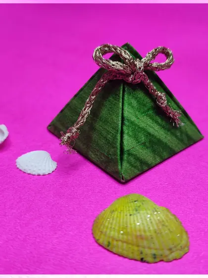 A pyramid-shaped gift box, showcasing another unique gift wrapping idea. Learn the art of paper engineering to create impressive packaging.