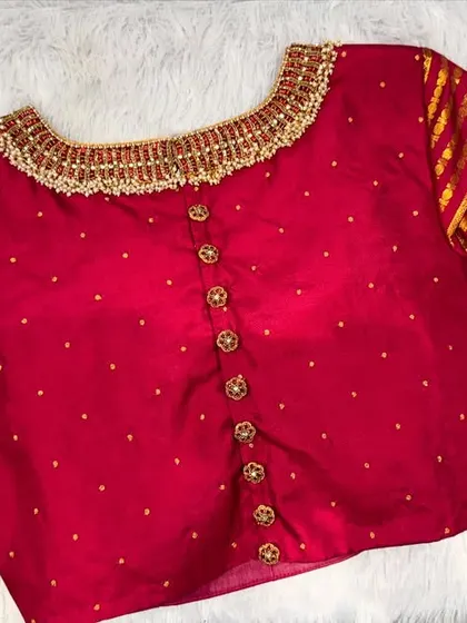 The back of the red jewelry-neck blouse, with a line of elegant buttons.