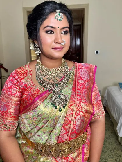 A side profile of the traditional maternity look, highlighting the elegant hairstyle and defined eye makeup.
