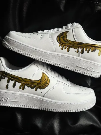 A pair shot of the liquid gold drip custom sneakers.