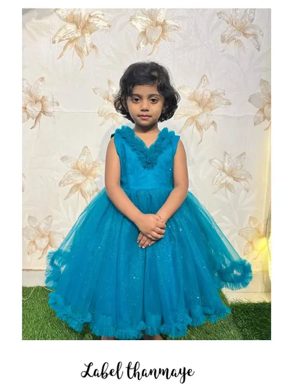 A sweet pose in the custom blue party frock.