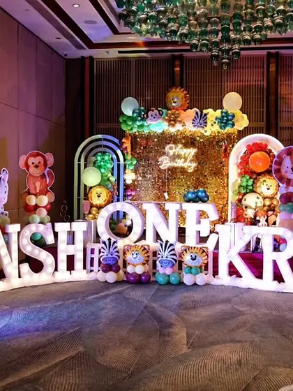 The grand decor for a first birthday party, featuring large, illuminated letters spelling out the children's names. We are experienced in capturing large-scale, elaborately themed events for kids.
