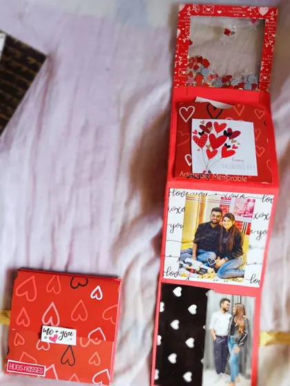 The zig-zag album partially folded, showing the shaker cover and the photos inside.